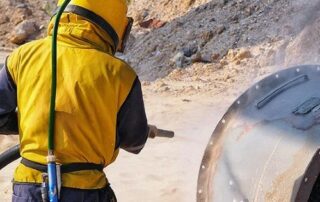 Cleaning metal surfaces by sandblasting 3